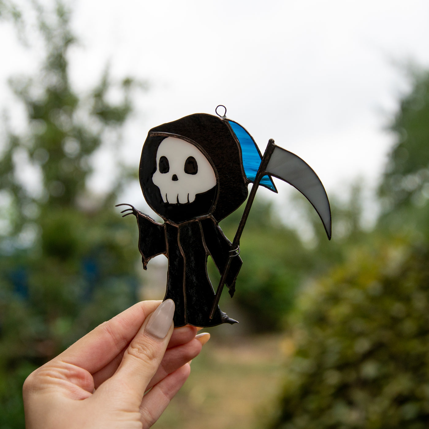 The Grim Reaper suncatcher of stained glass for ghastly Halloween decor