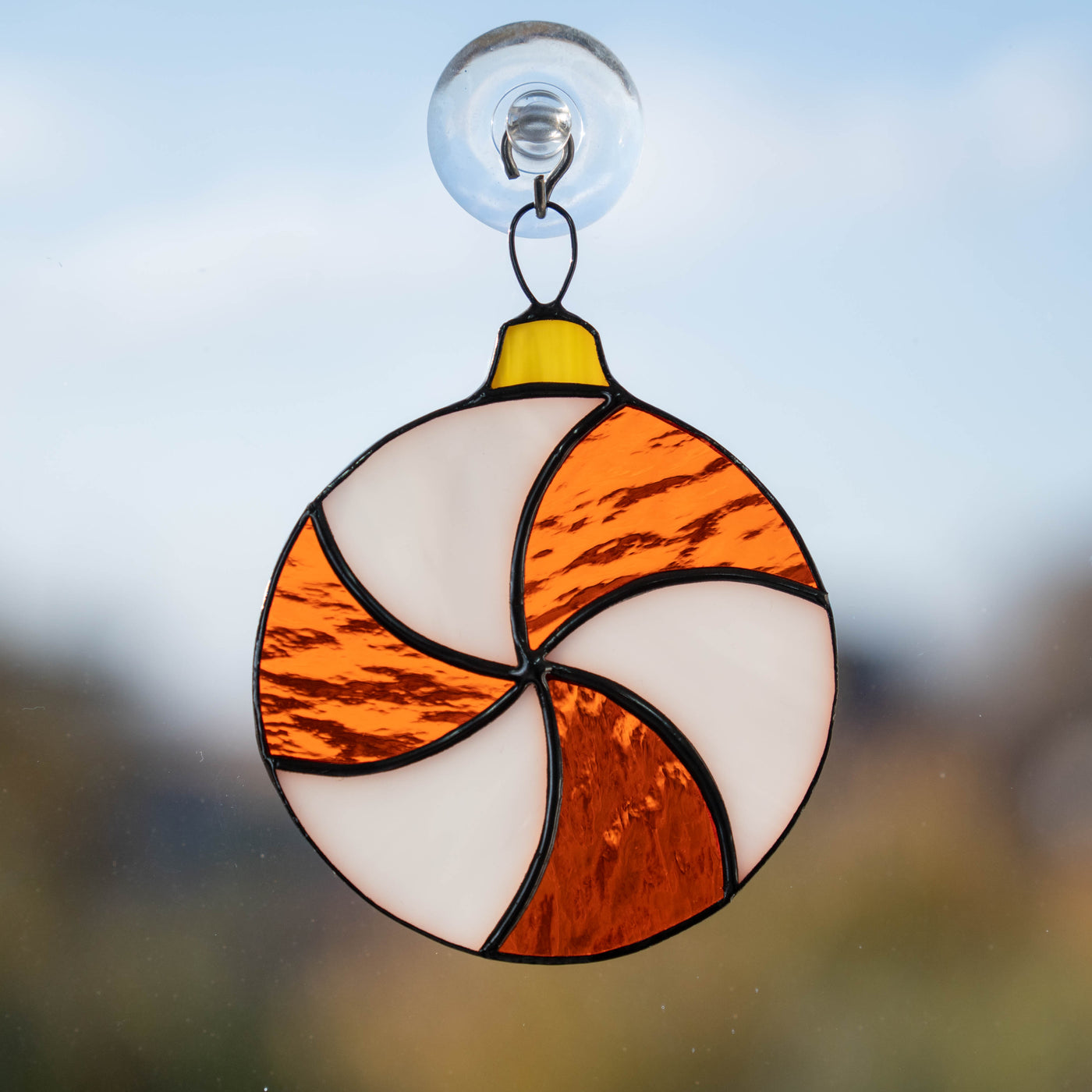 Round white and orange candy suncatcher of stained glass