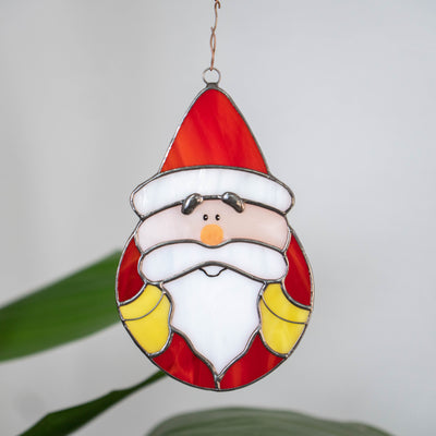 Santa Claus in oval shape suncatcher of stained glass