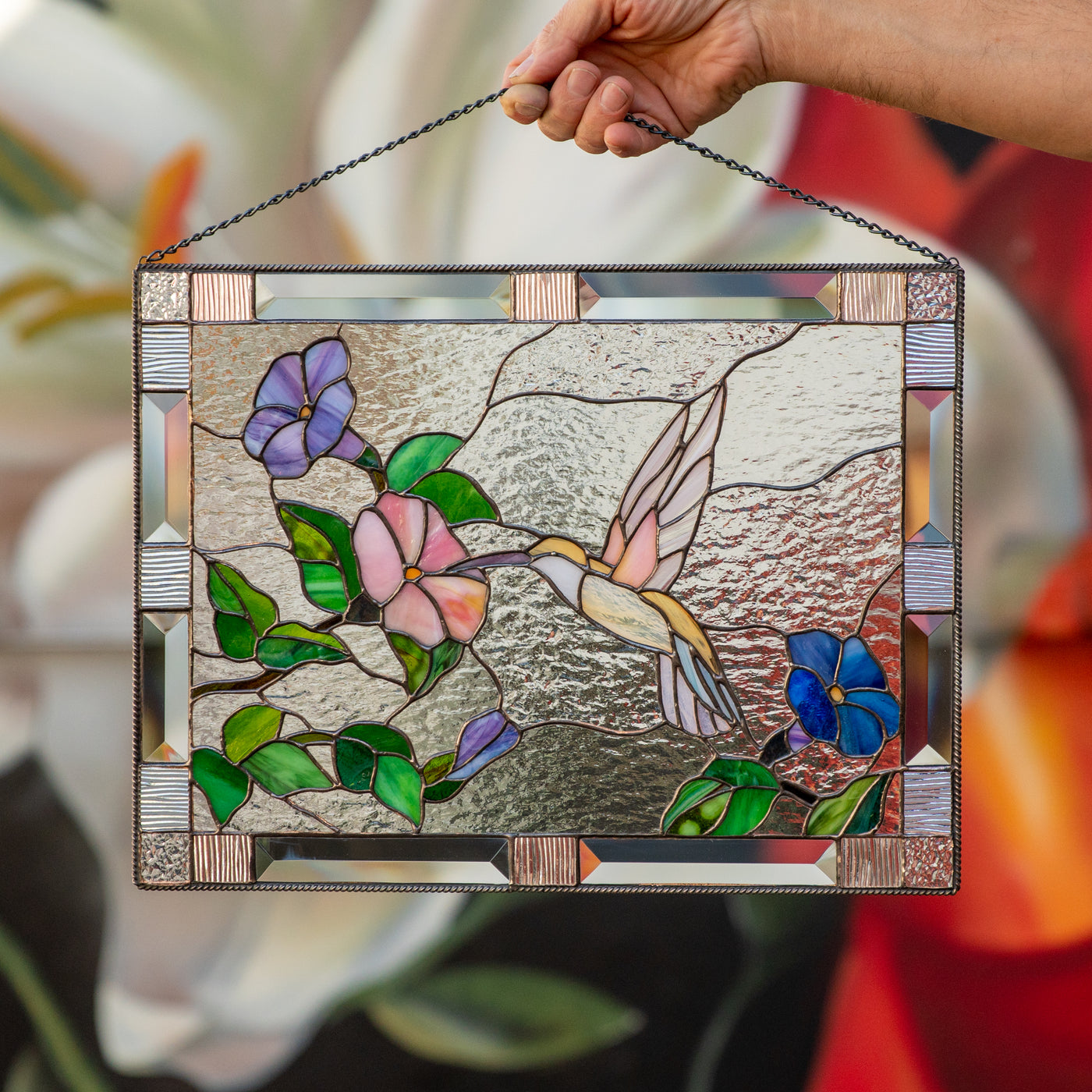 Stained glass panel depicting a flying hummingbird towards the flower 