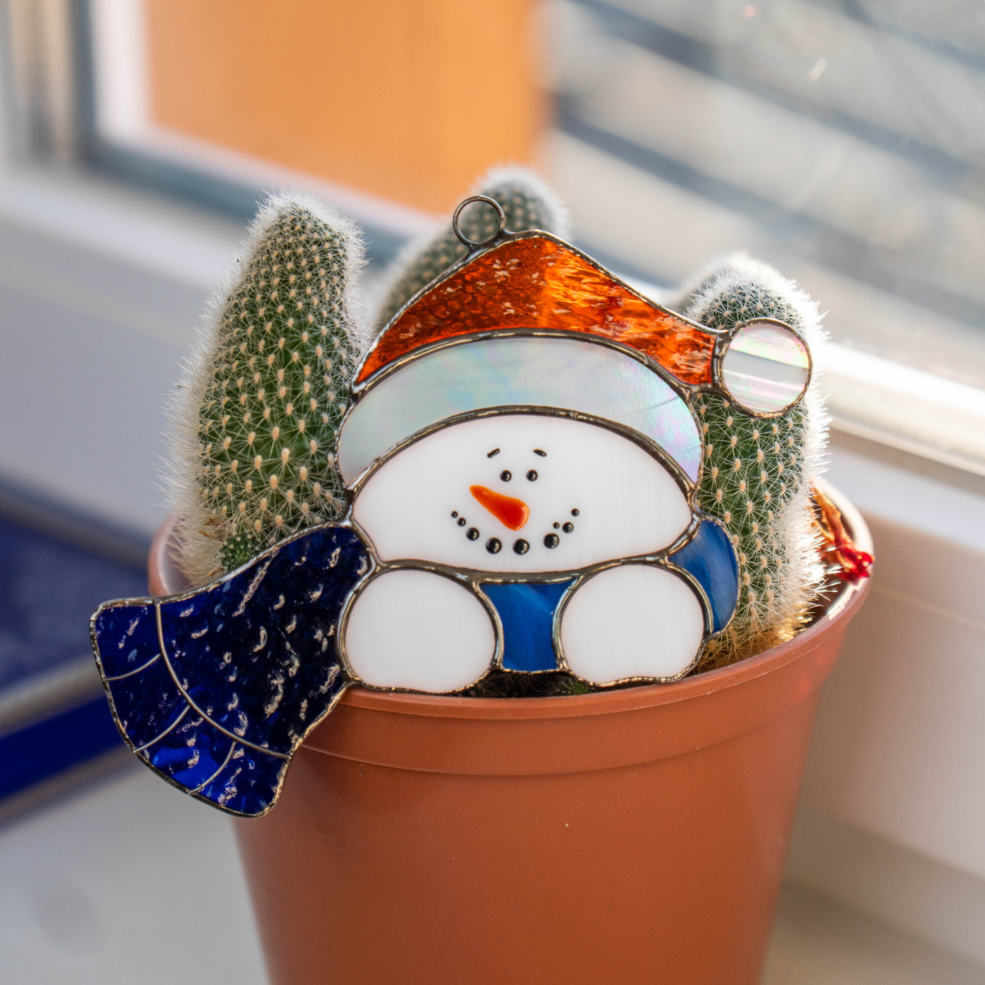 Snowman in blue scarf window hanging of stained glass