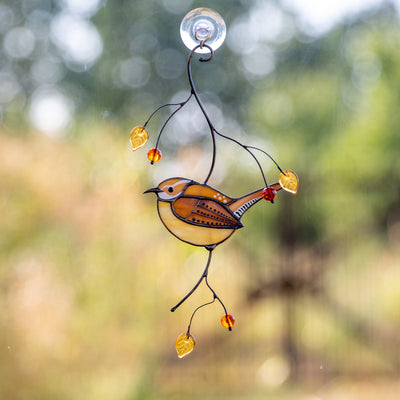 Stained glass suncatcher of Carolina wren sitting on the branch with leaves and berries