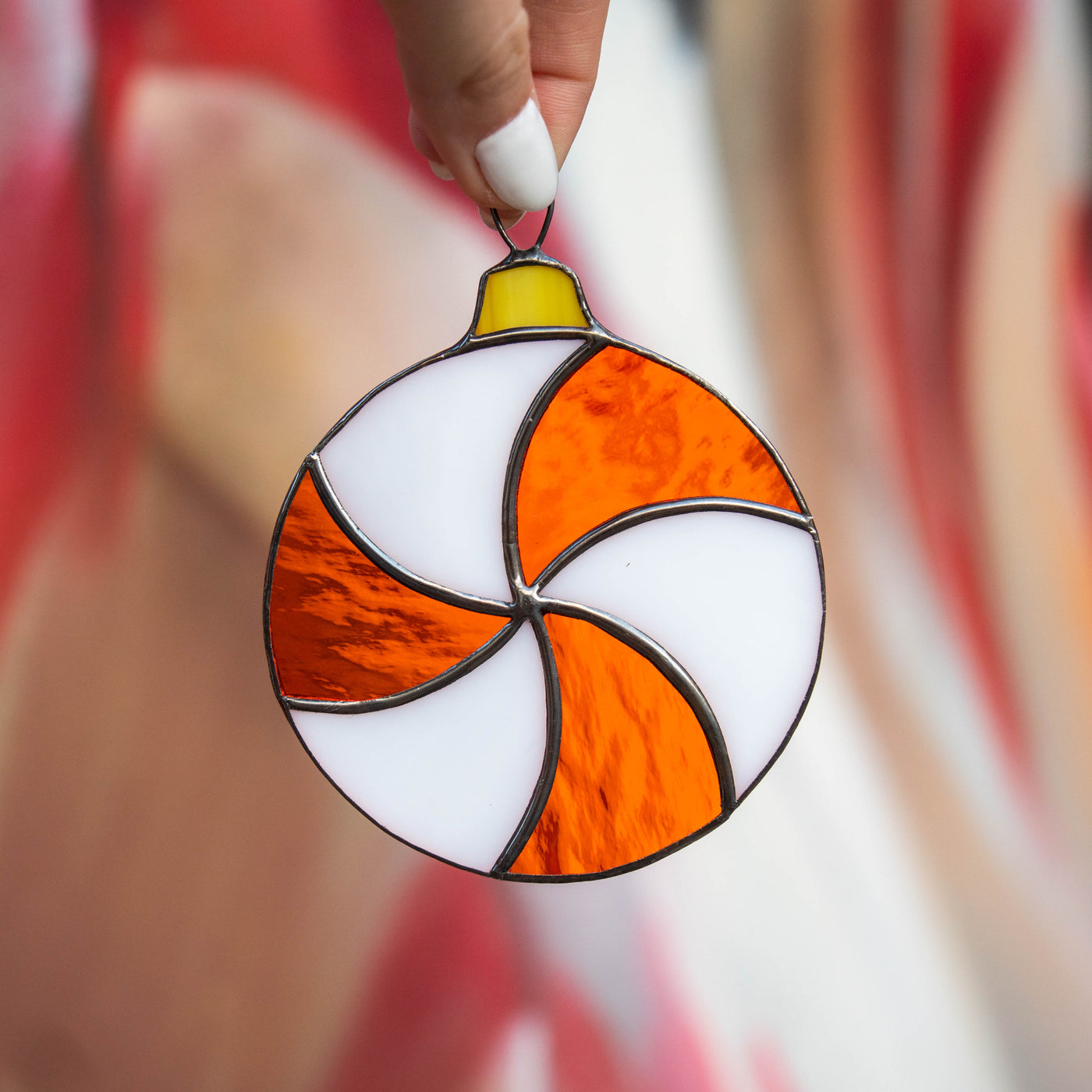Round white and orange candy suncatcher of stained glass for Christmas decor