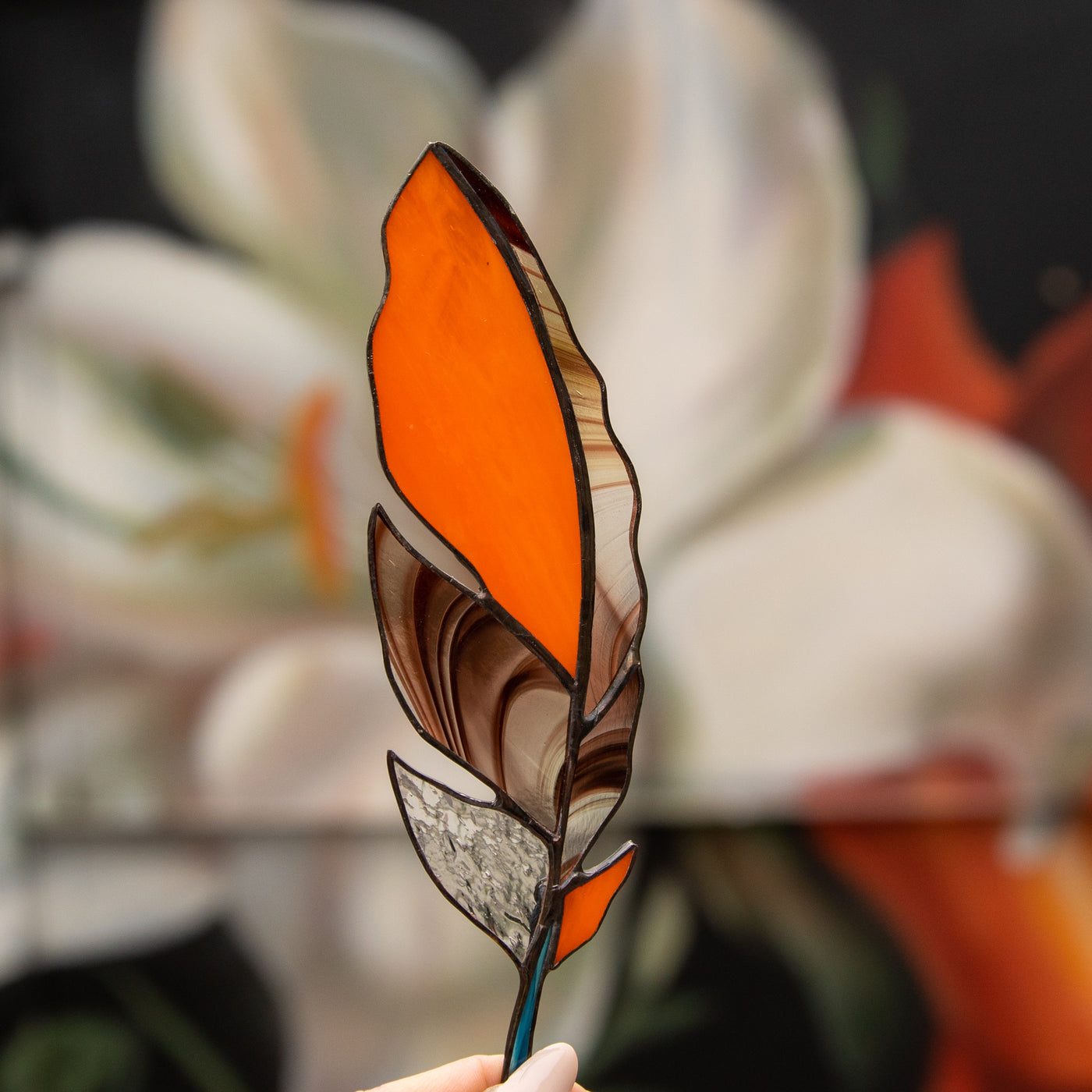 Orange with blotchiness stained glass feather suncatcher