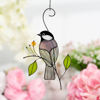 Stained glass window hanging of a chickadee from the back