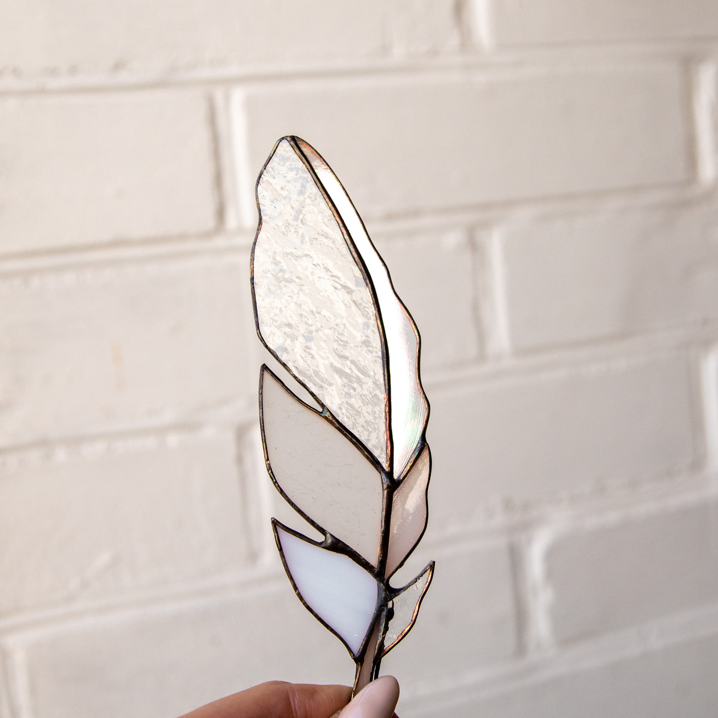 White with clear parts stained glass feather window hanging