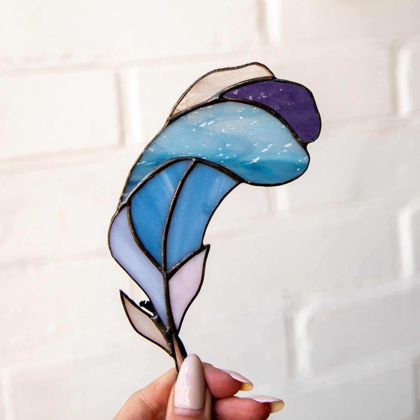 Bright stained glass feather of blue and purple colours suncatcher