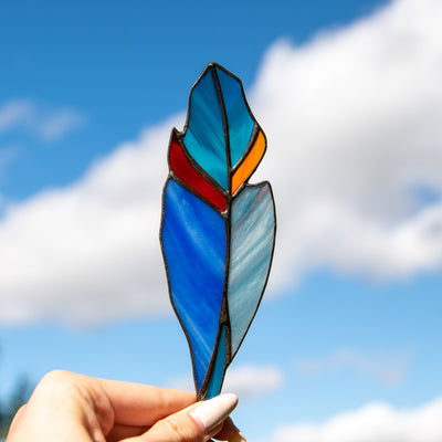 Bright stained glass feather suncatcher of blue colours for window decoration