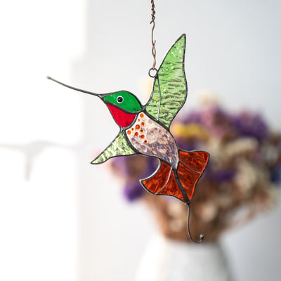 Hummingbird with green wings and orange tail window hanging of stained glass