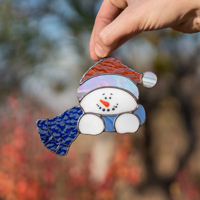Stained glass snowman in blue scarf suncatcher for Christmas party