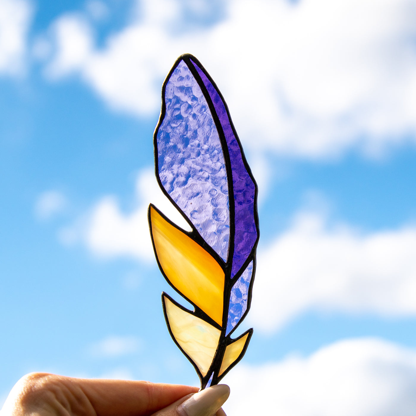 Bright stained glass purple feather suncatcher with yellow parts