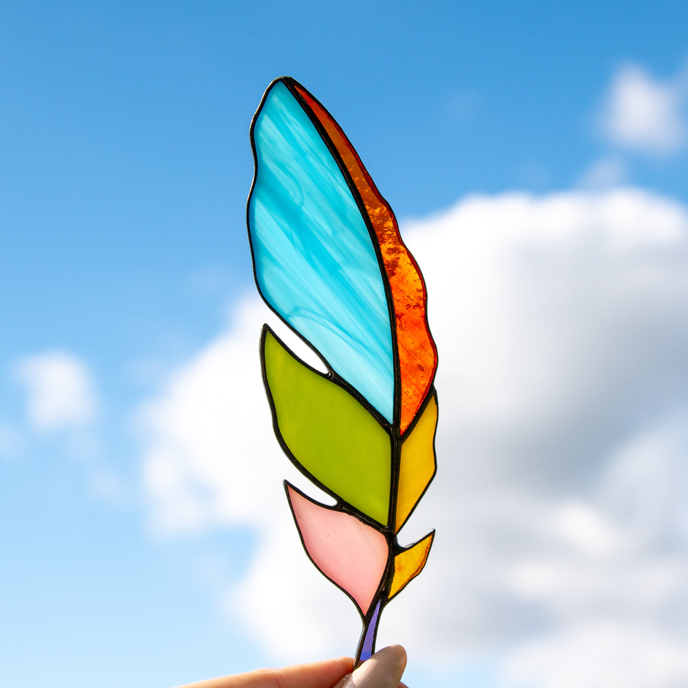 Bright colourful stained glass feather suncatcher