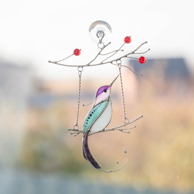 Stained glass purple hummingbird with white belly on the swing suncatcher 
