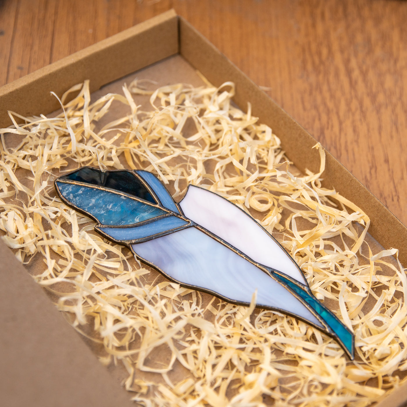 Stained glass blue feather with navy and white parts 