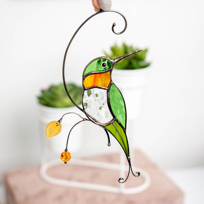Zoomed hummingbird with transparent belly and orange throat suncatcher