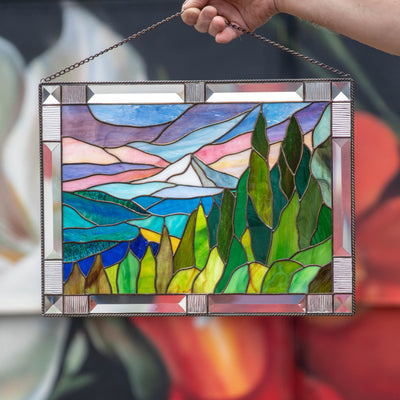Stained glass panel depicting mount Hood with its adjacent flora