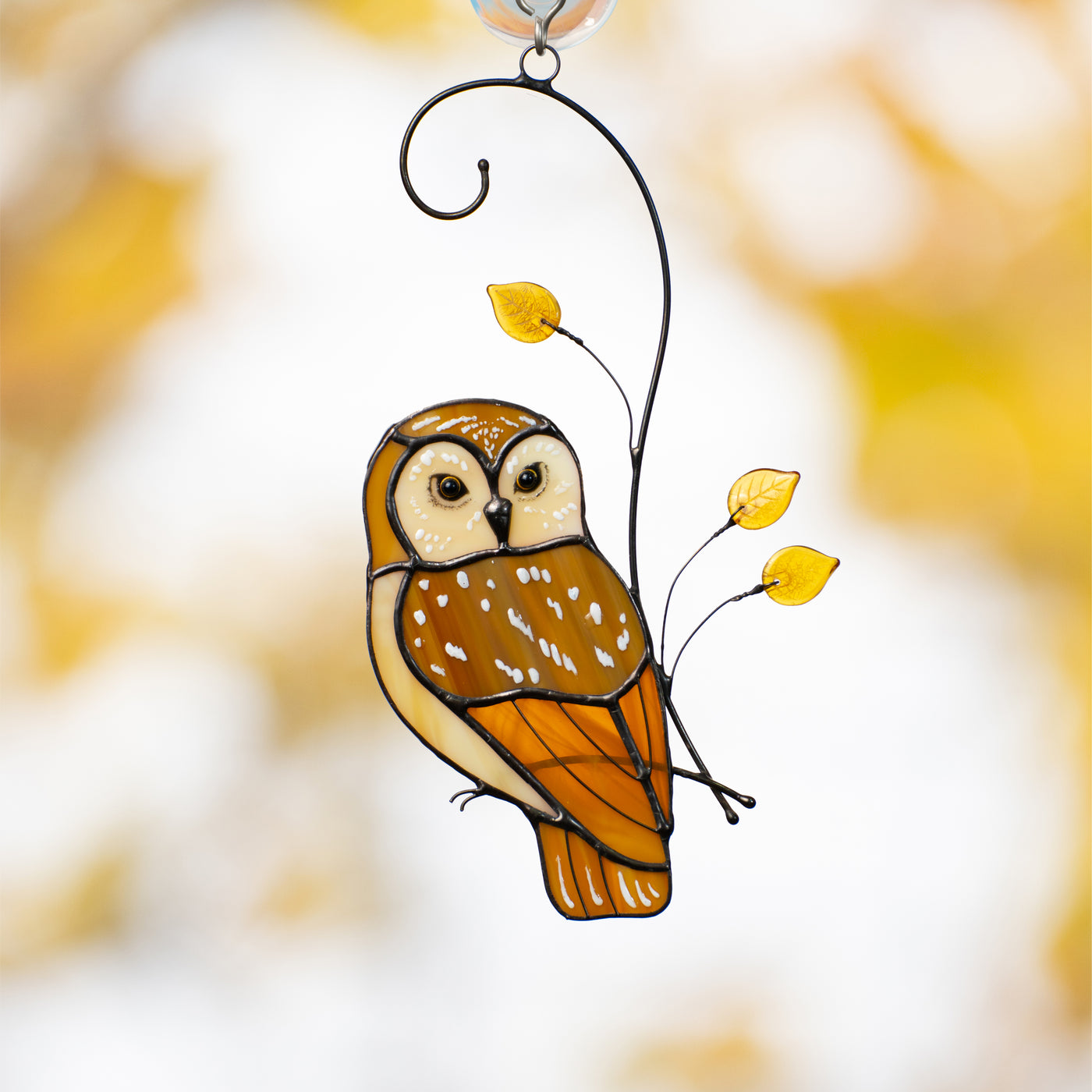 Stained glass owl sitting on the branch with yellow leaves suncatcher