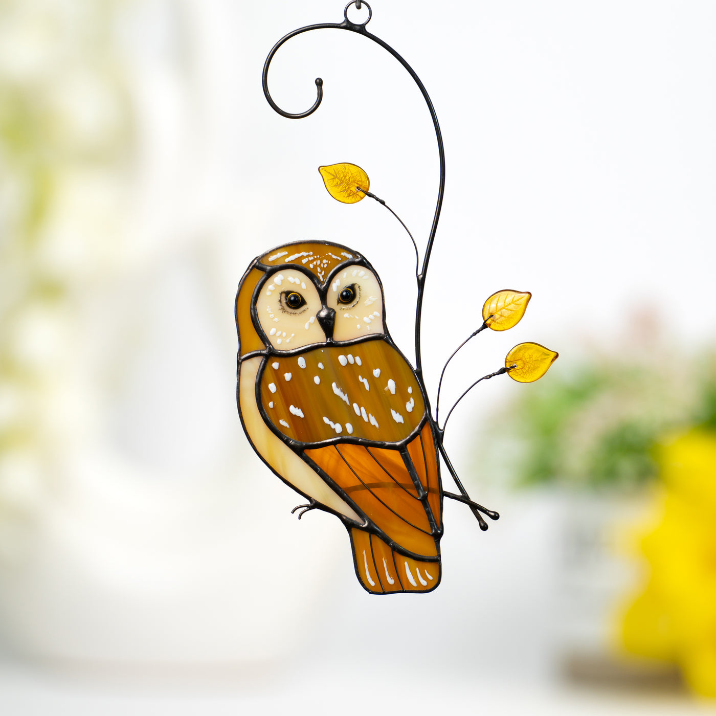 Stained glass window hanging of an owl on the branch