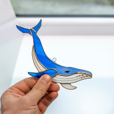 Stained glass suncatcher of a royal blue whale for home decoration