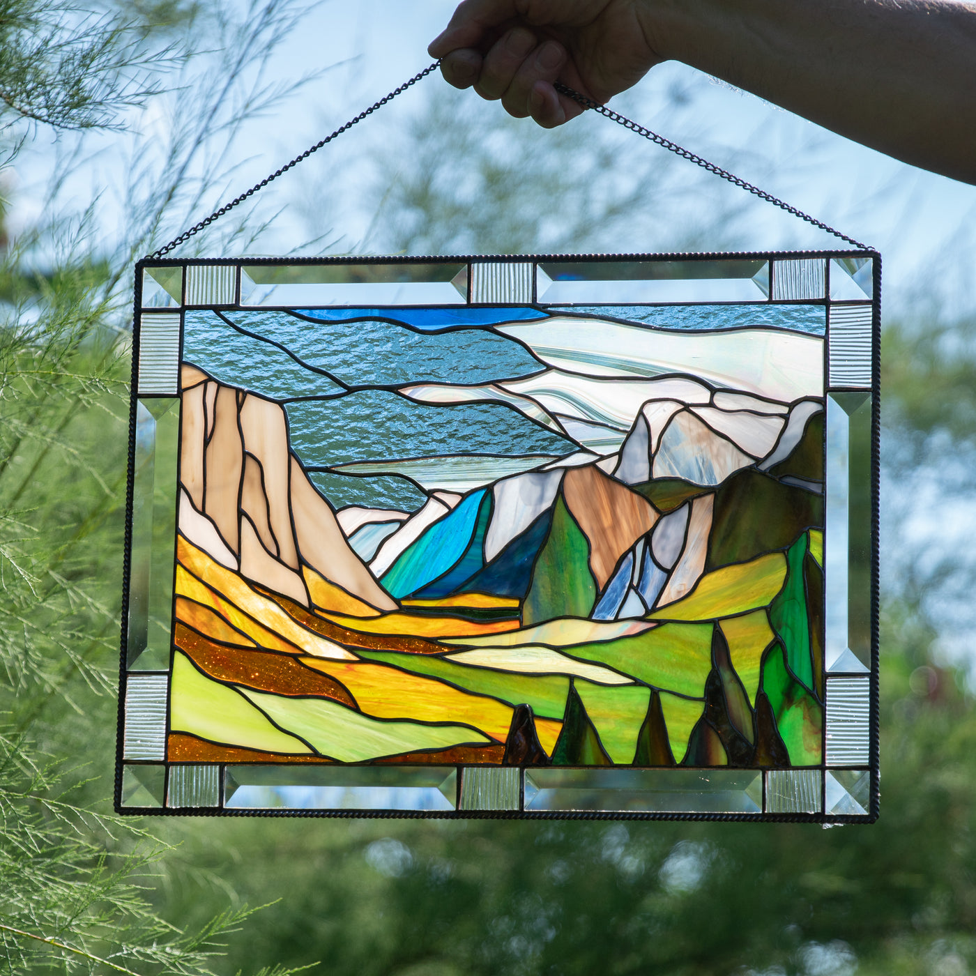 Stained glass window hanging depicting Yosemite national park