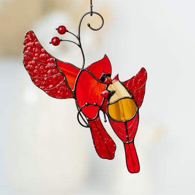 Stained glass cardinal couple in flight, accented with red glass beads.
