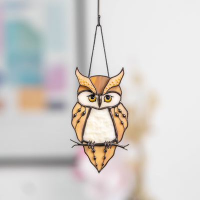 Detailed view of great horned owl stained glass suncatcher with expressive yellow eyes and decorative dotted glasswork.