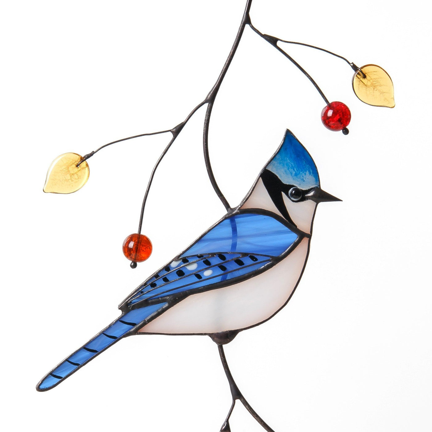 Stained glass blue jay with top knot sitting on the branch window hanging
