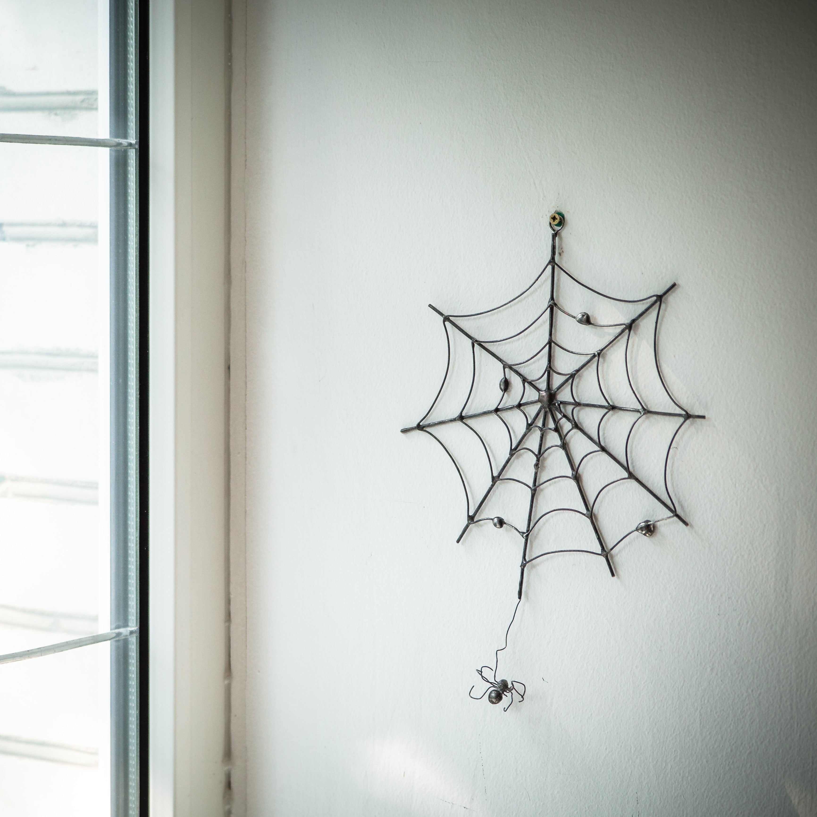 Creepy round spider web for Halloween decorations as a wall hanging