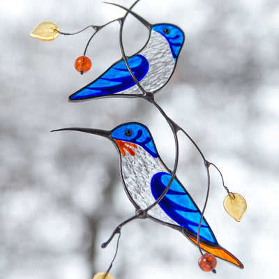 Blue stained glass hummingbirds on the branch window hanging