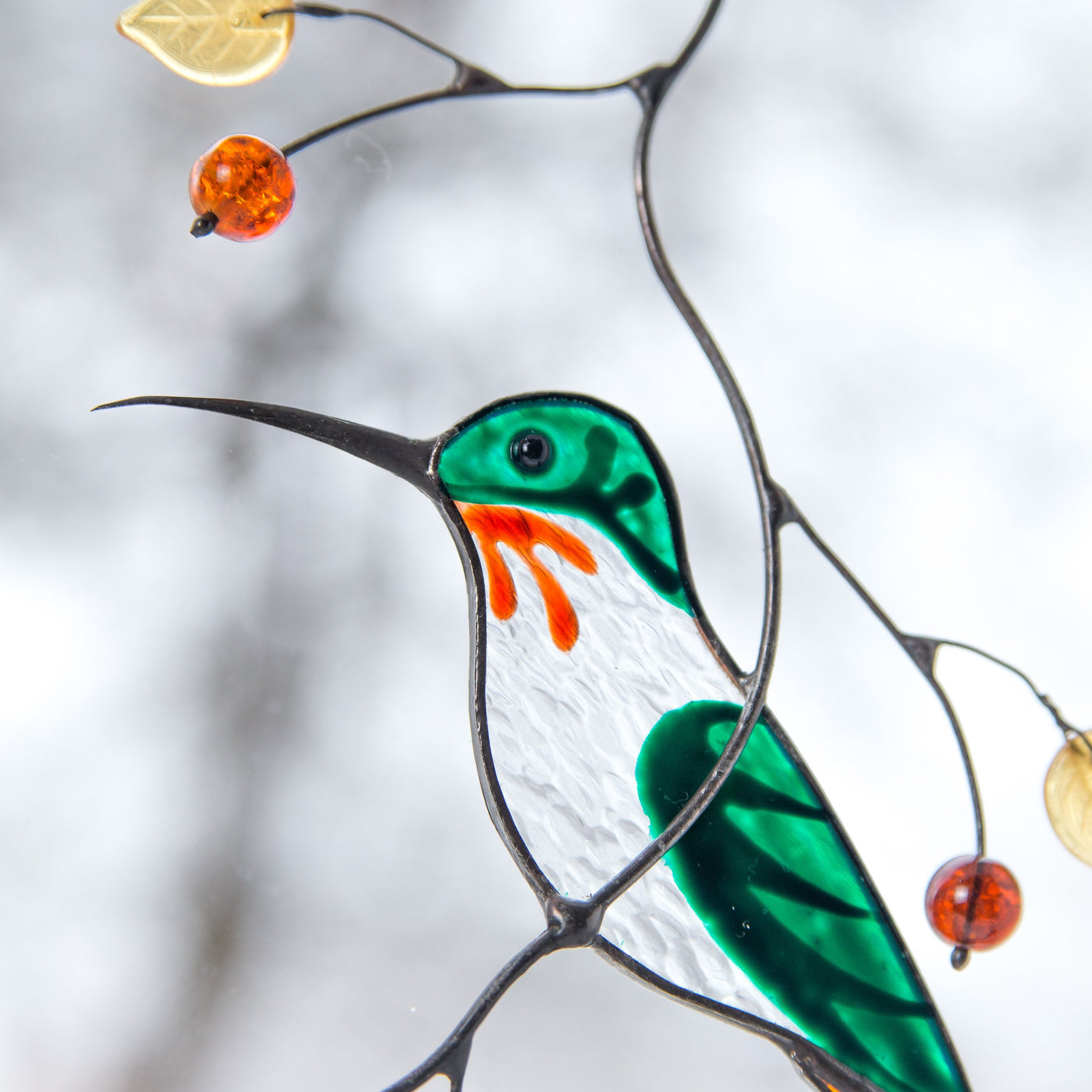 Zoomed stained glass male hummingbird suncatcher