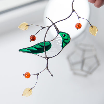 Stained glass green female hummingbird on the branch suncatcher