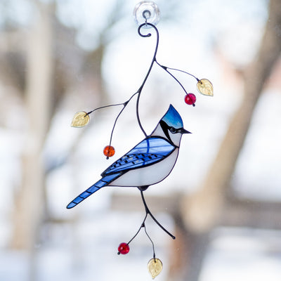 Sitting on the branch stained glass blue jay with top knot window hanging