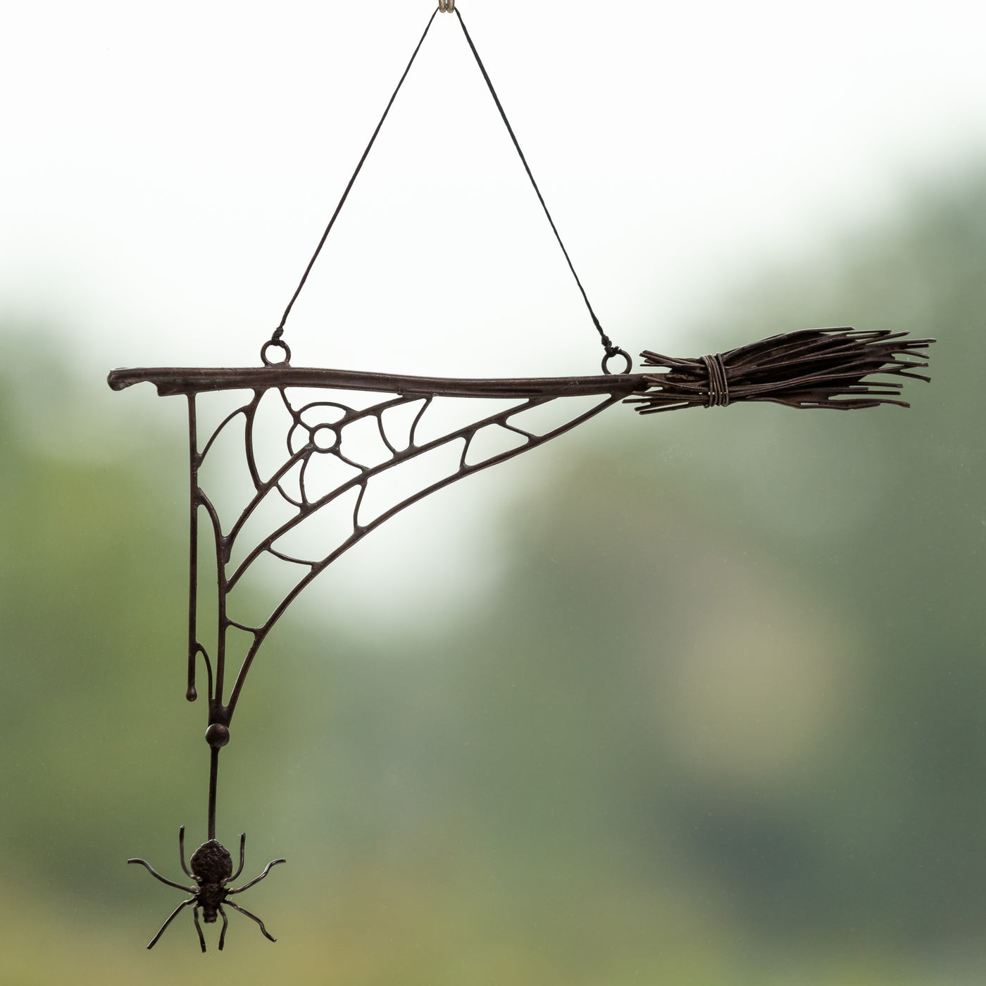 Wire Halloween spider web with the broom and spider in the lower part for window