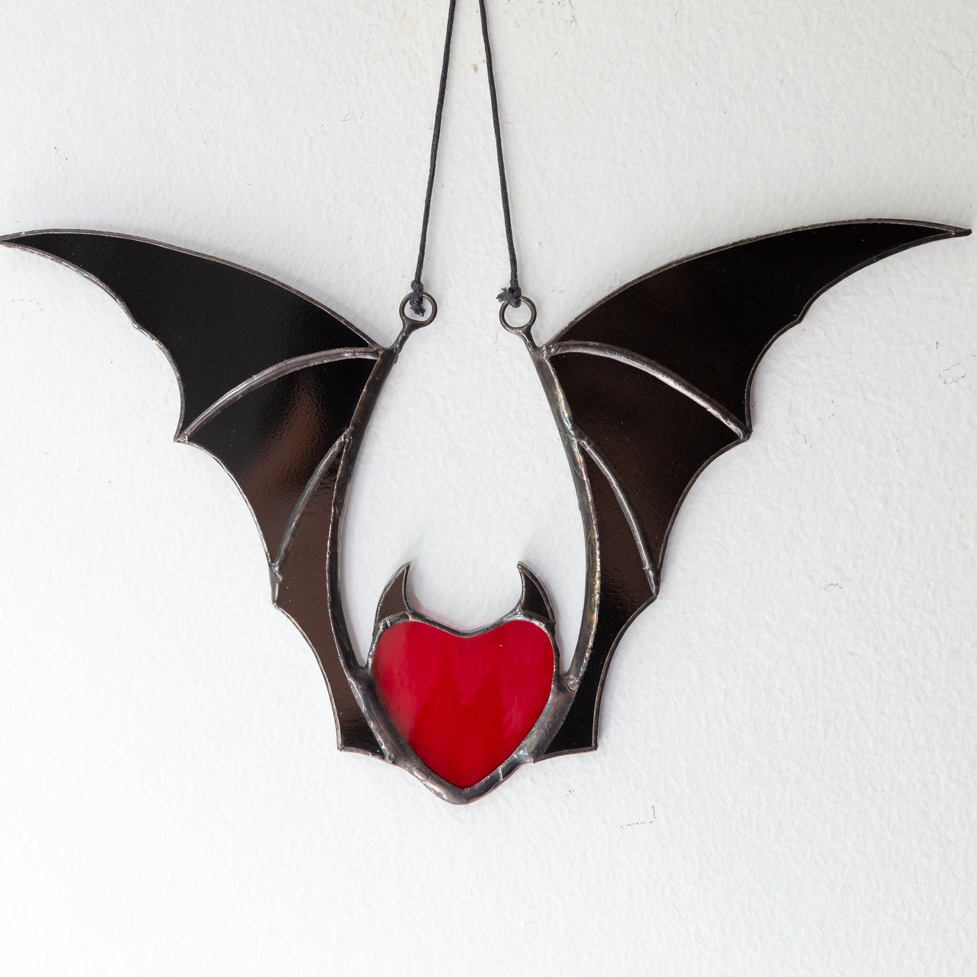 Red stained glass vampire heart with black wings Halloween creepy window hanging