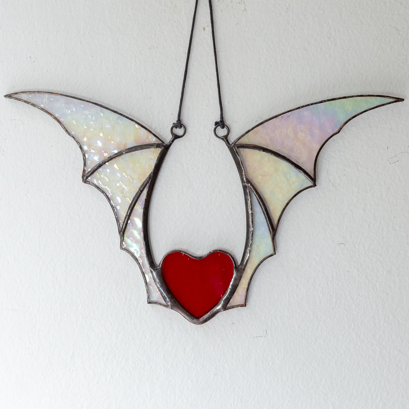 Red stained glass heart wit iridescent wings for Halloween celebration