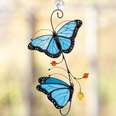 Stained glass morpho butterflies sitting on the branch suncatcher