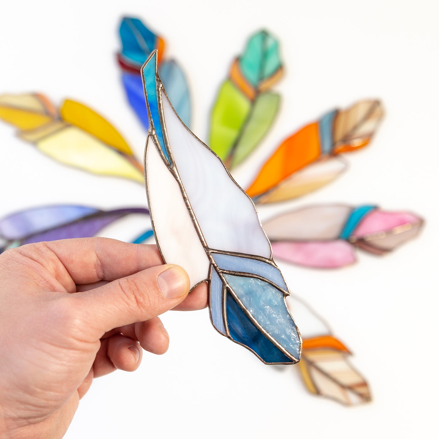 Suncatcher of a blue stained glass feather