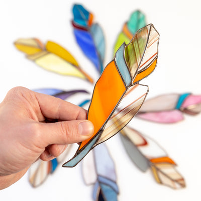 Stained glass orange feather with shades of blue suncatcher