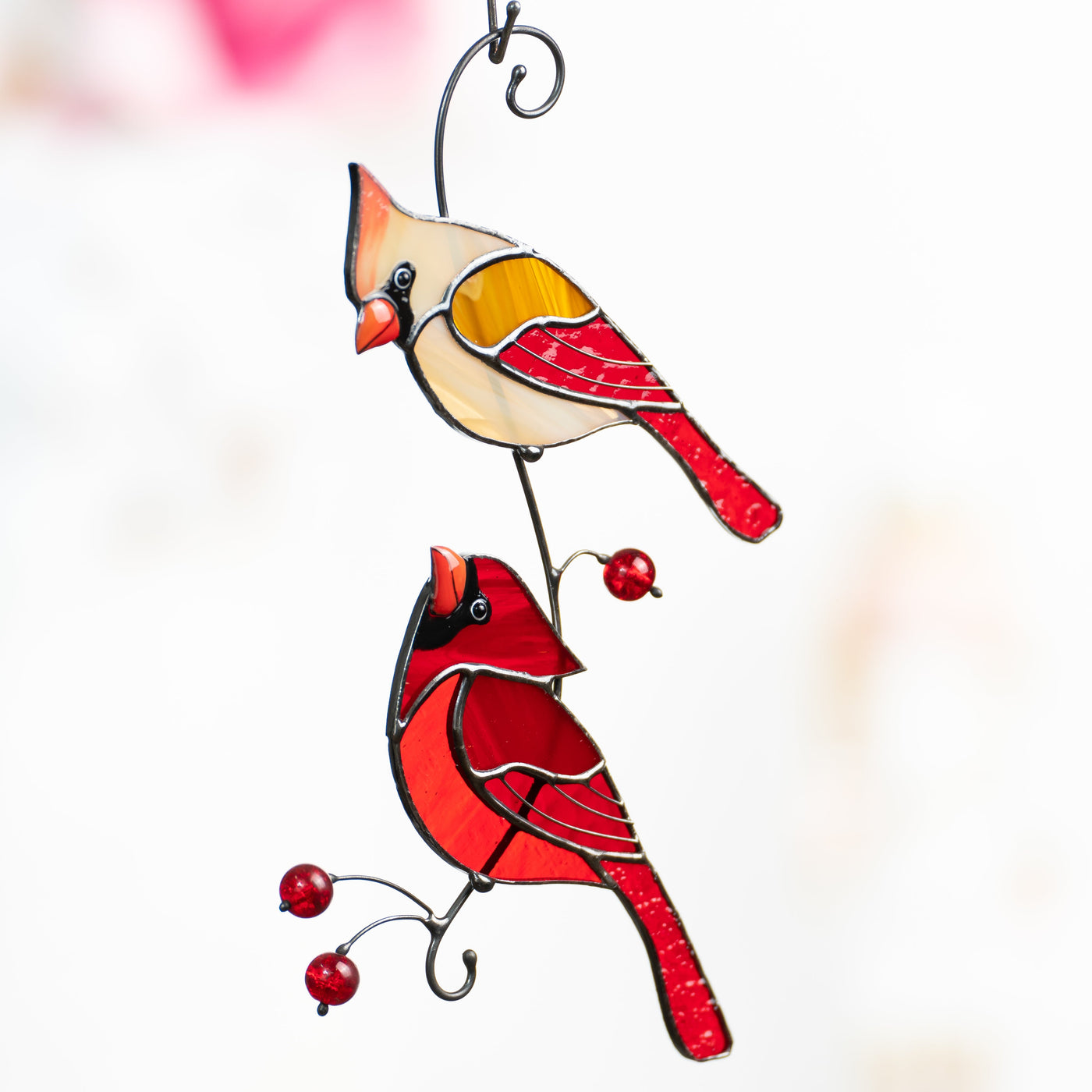 Stained glass window hanging of male and female cardinals looking at each other