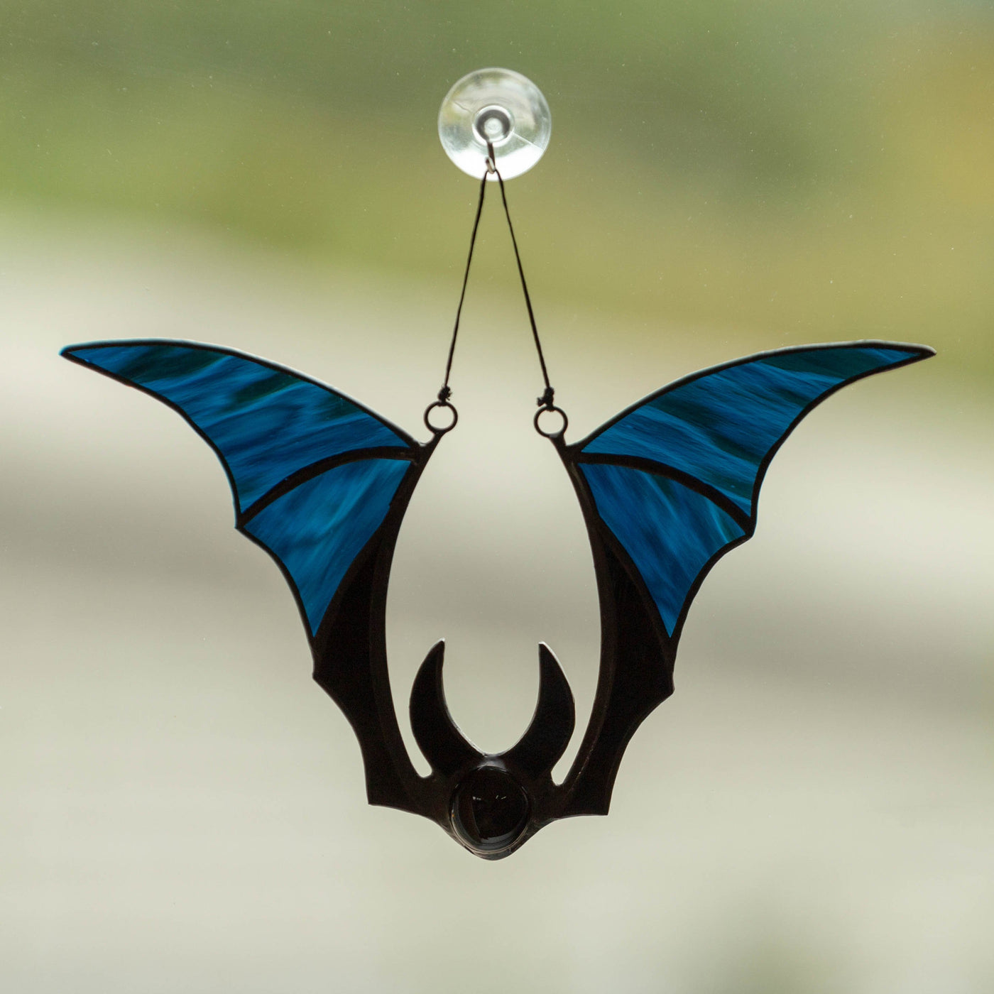Suncatcher of a stained glass blue-winged bat 