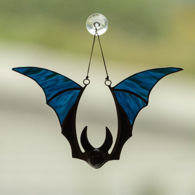 Suncatcher of a stained glass blue-winged bat for Halloween