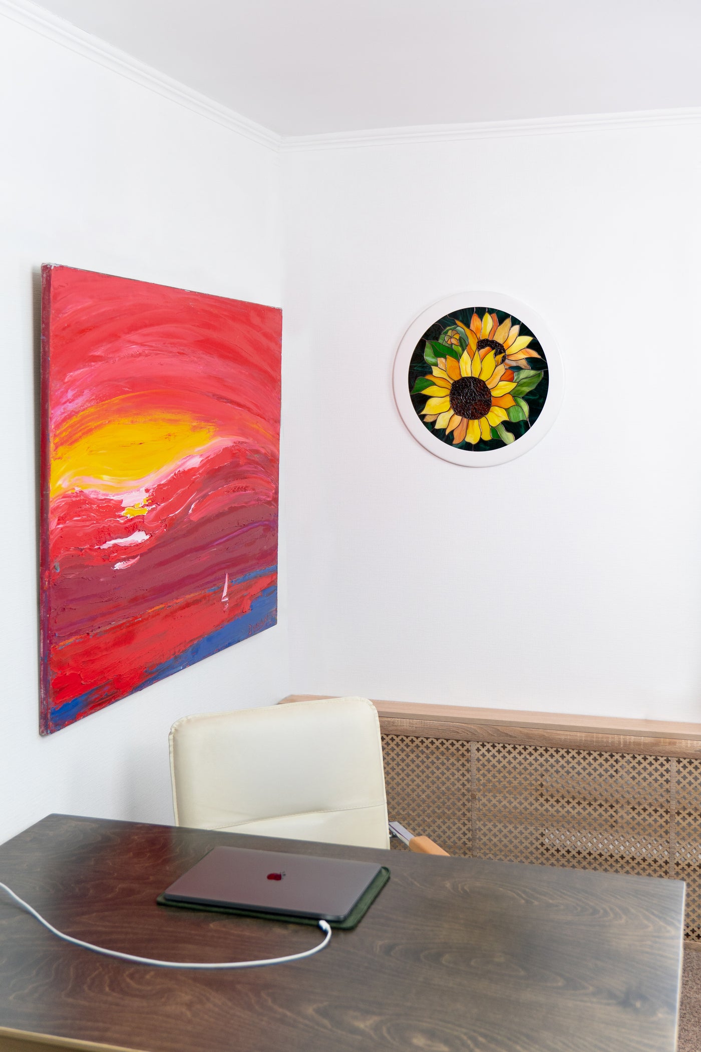 Round stained glass panel predicting sunflowers on the wall