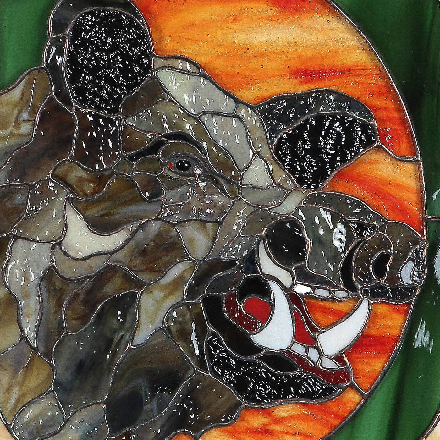 Zoomed stained glass boar's head with its razors panel