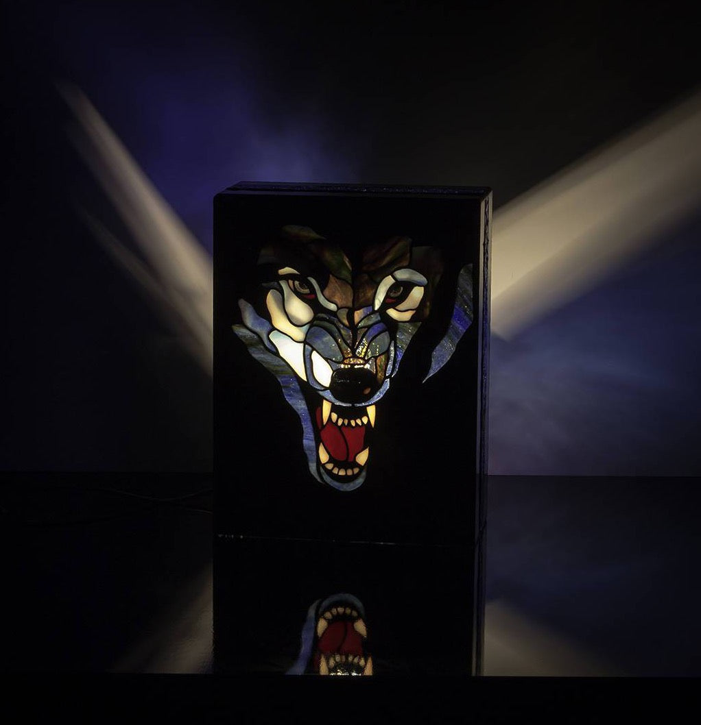 Lit stained glass lamp with angry wolf's head