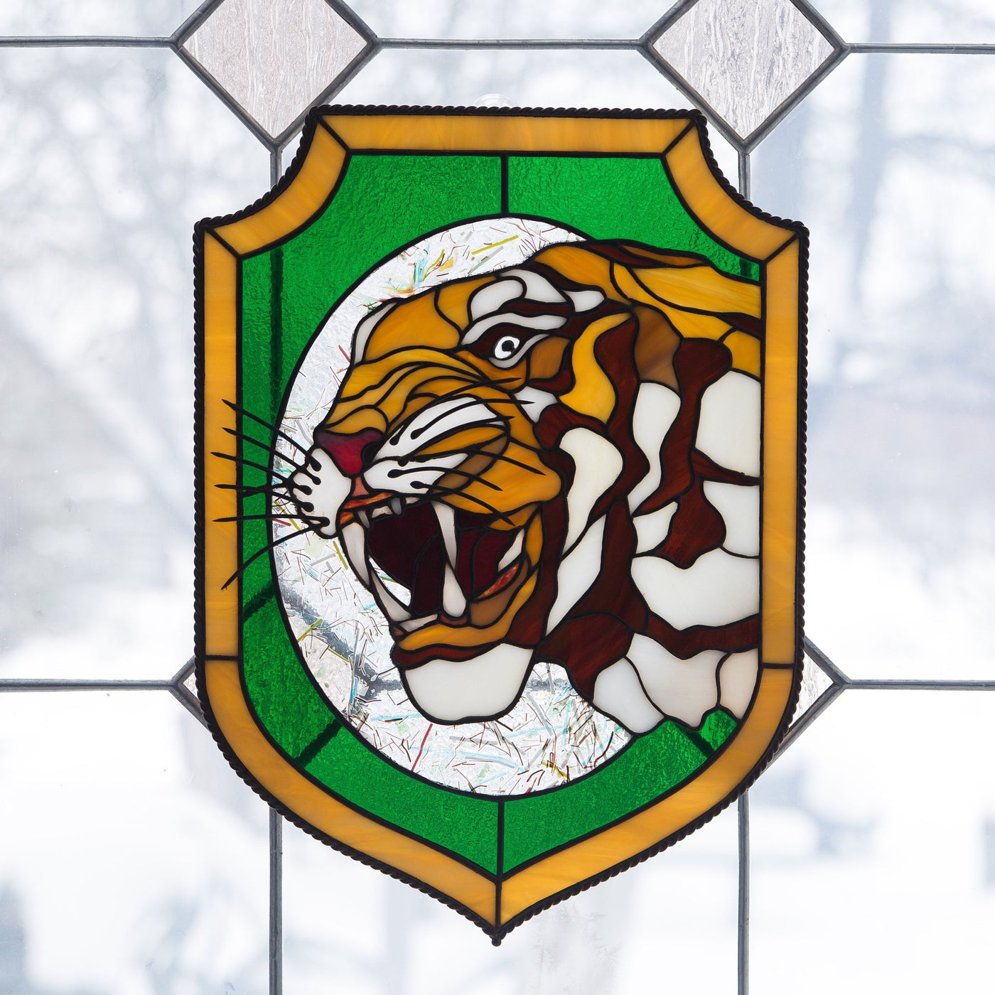 Tiger showing his fangs panel of stained glass