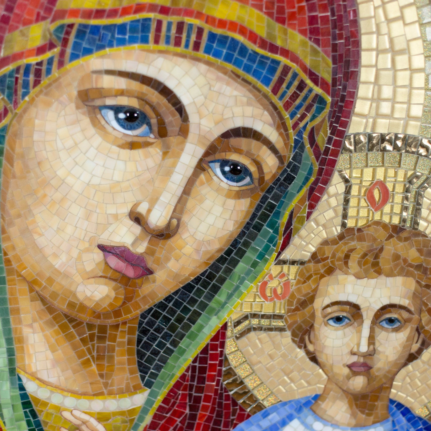Zoomed stained glass faces of Virgin Mary and Jesus Christ mosaic