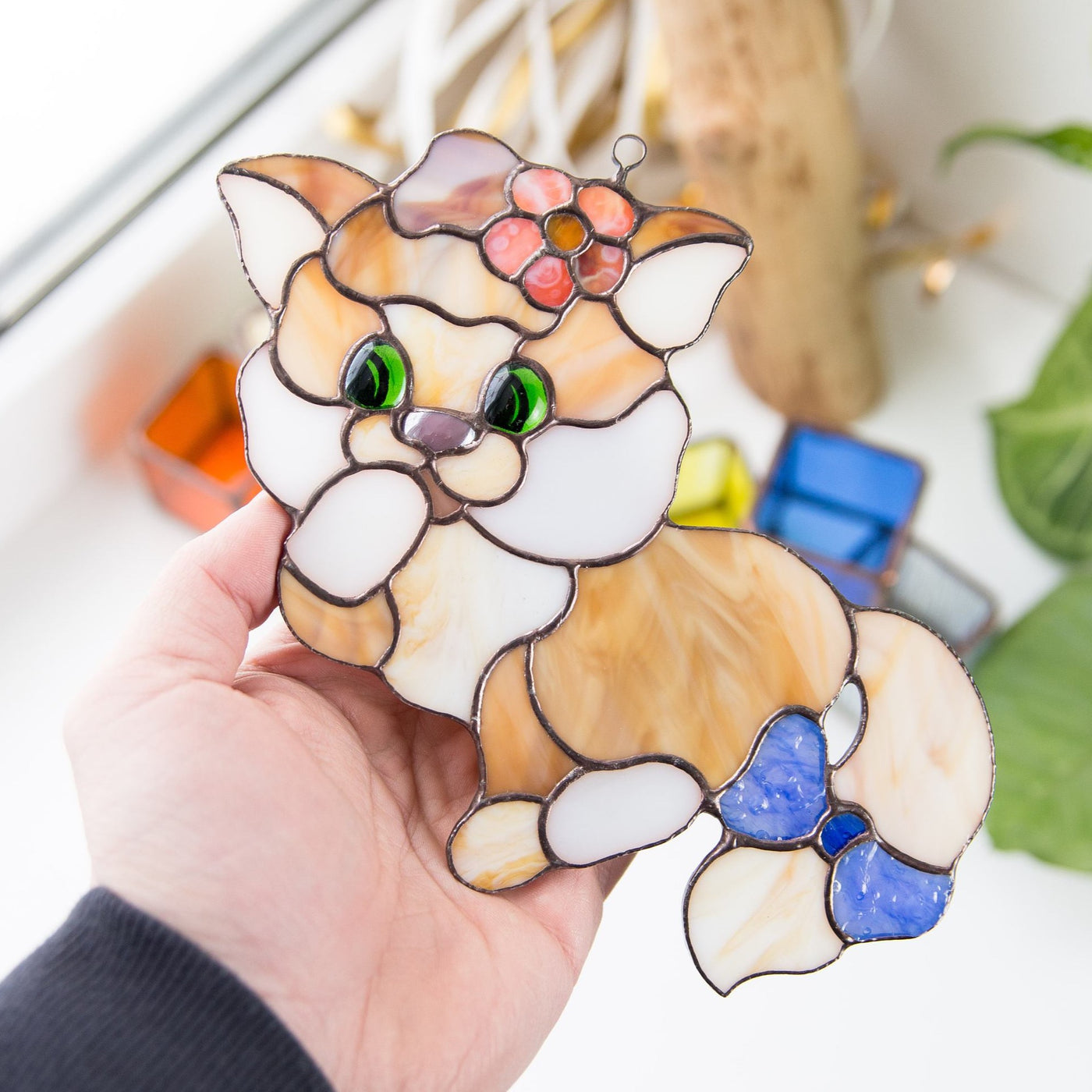 Window hanging of a stained glass kitty with the bow on the tail
