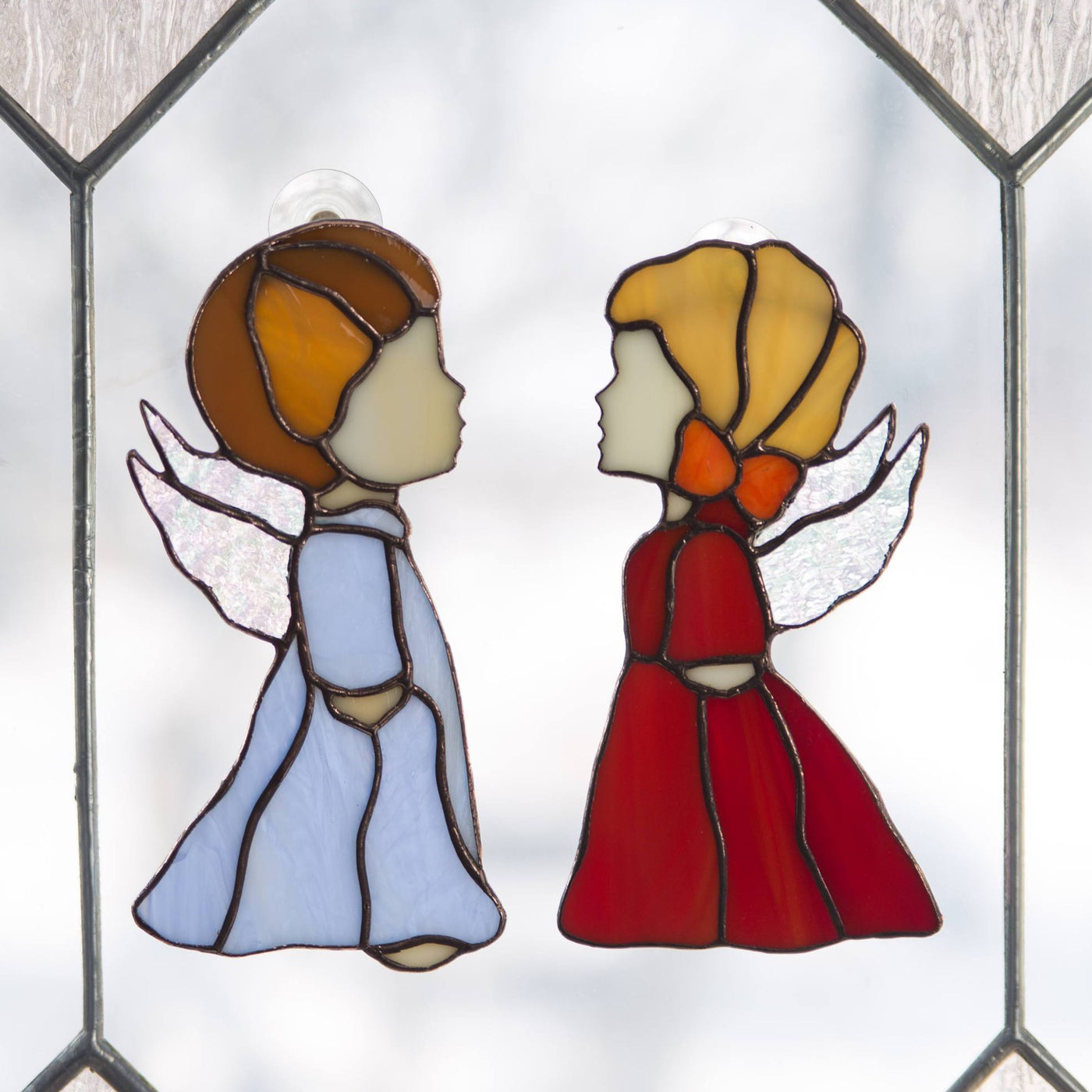 Window hanging of stained glass blue angel boy and red angel girl
