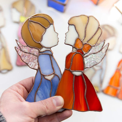 Blue boy angel and red girl angel suncatchers of stained glass