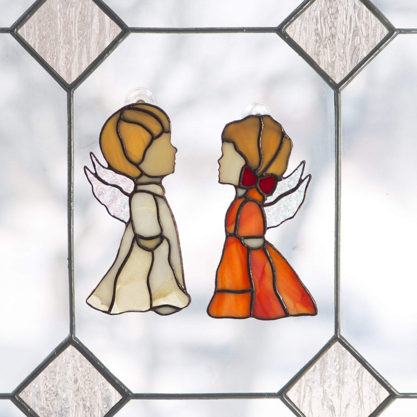 Suncatchers of stained glass beige angel boy and red angel girl